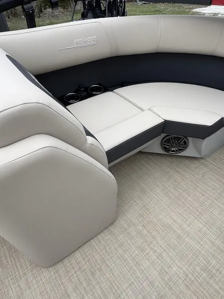 Slide: The Image of 2025 Harris Cruiser 230 boat interior with beige seating and cup holders. - 6