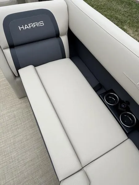 Slide: The Image of 2025 Harris Cruiser 230 boat interior with beige seating and cup holders. - 7