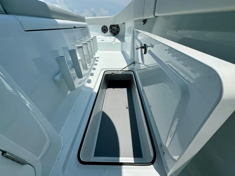 Slide: The Image of 2024 Freeman 38 boat interior with open storage compartment and rod holders. - 28