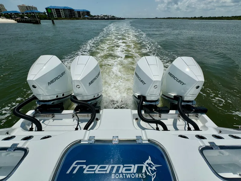 Slide: The Image of Four Mercury engines on a 2024 Freeman 38 boat cruising on open water. - 31