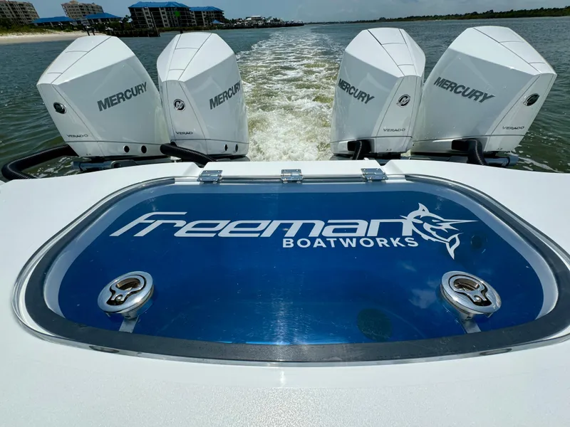 Slide: The Image of 2024 Freeman 38 boat with four Mercury engines, cruising on water. - 32