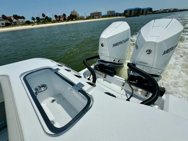 Slide: The Image of 2024 Freeman 38 boat with dual Mercury outboard engines on a sunny day near the shore. - 34