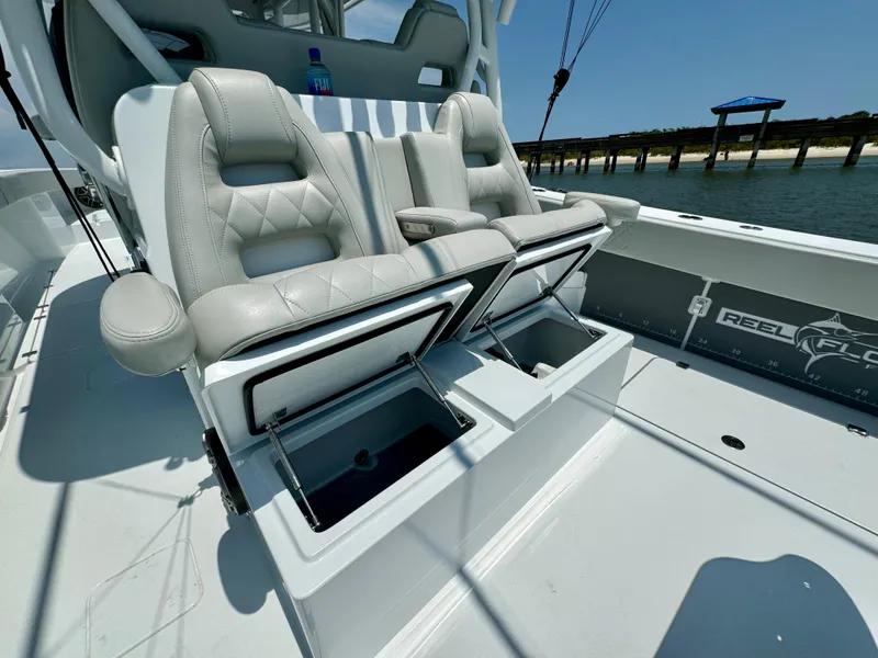 Slide: The Image of Luxury seating on 2024 Freeman 38 boat with storage compartments open. - 39