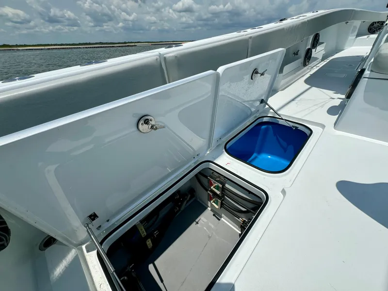 Slide: The Image of Open storage compartments on a 2024 Freeman 38 boat deck, with ocean view. - 45