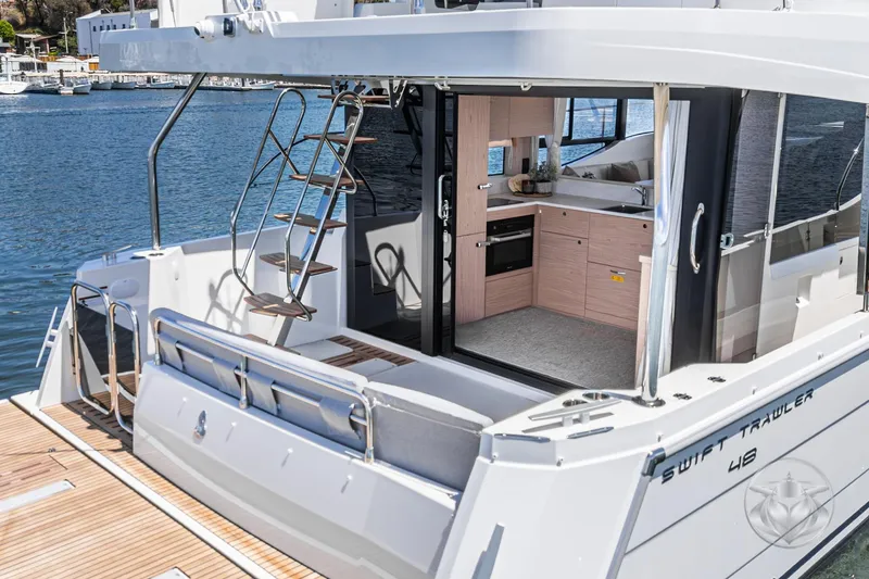 Slide: The Image of 2026 Beneteau Swift Trawler 48, featuring modern interior and exterior design on the water. - 12
