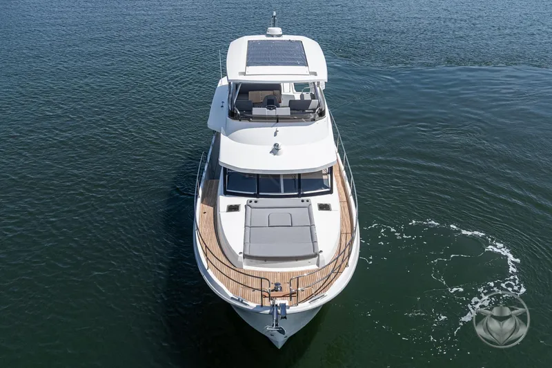 Slide: The Image of 2026 Beneteau Swift Trawler 48 cruising on calm waters, aerial view. - 14