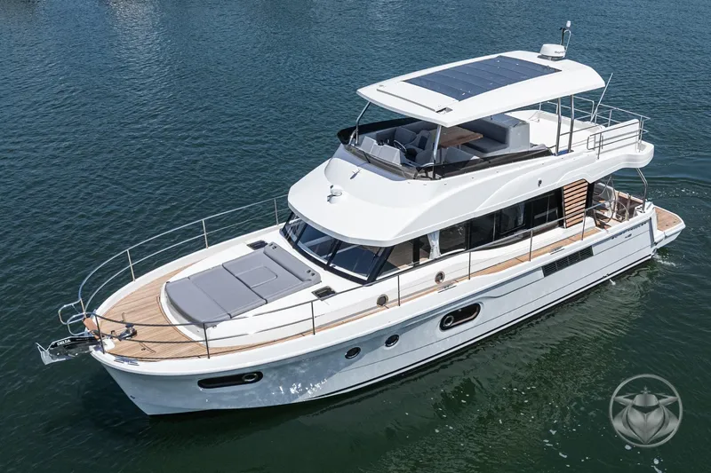 Slide: The Image of 2026 Beneteau Swift Trawler 48 cruising on calm waters, showcasing sleek design and spacious deck. - 16