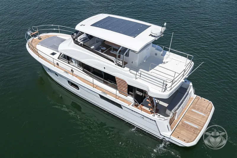 Slide: The Image of 2026 Beneteau Swift Trawler 48 cruising on calm waters, showcasing sleek design and spacious deck. - 17