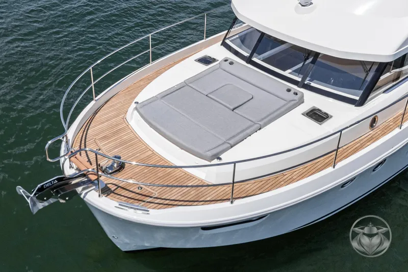 Slide: The Image of 2026 Beneteau Swift Trawler 48 with spacious deck and modern design on the water. - 2