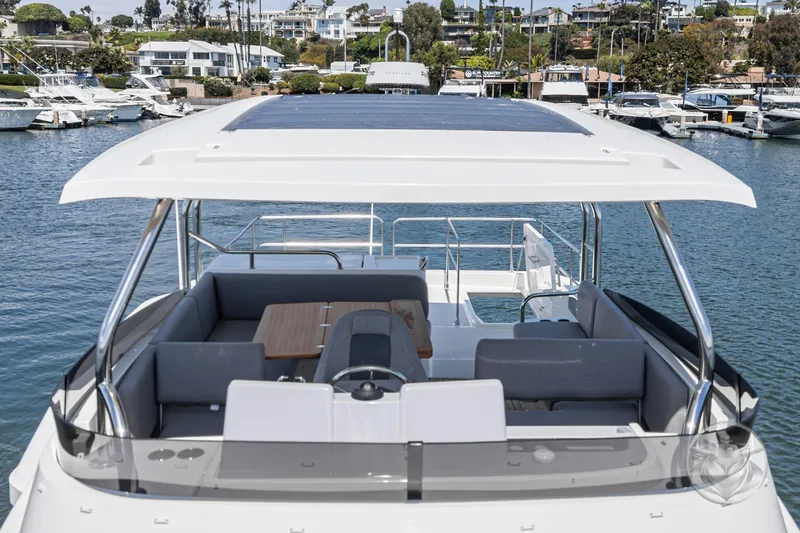 Slide: The Image of 2026 Beneteau Swift Trawler 48, spacious deck view, docked in a marina. - 22