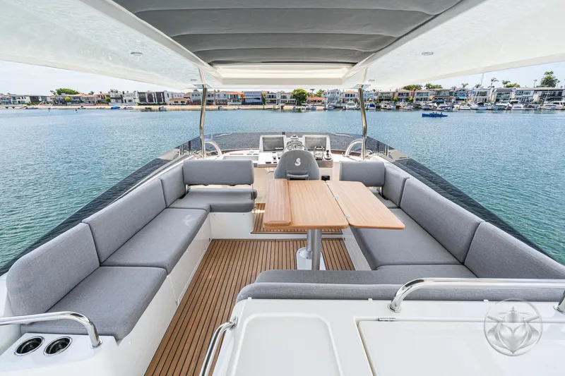 Slide: The Image of 2026 Beneteau Swift Trawler 48, spacious deck with seating, overlooking serene waterfront. - 25