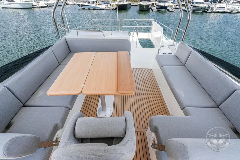 Slide: The Image of Luxurious seating area on 2026 Beneteau Swift Trawler 48, docked at marina. - 27