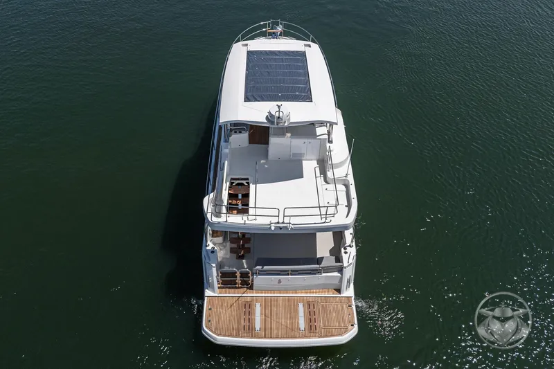 Slide: The Image of 2026 Beneteau Swift Trawler 48, aerial view, cruising on calm water. - 29