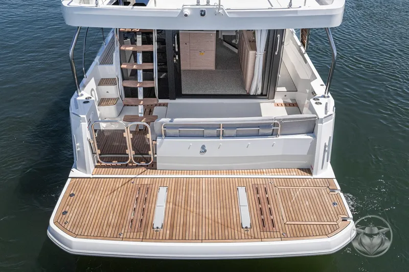 Slide: The Image of 2026 Beneteau Swift Trawler 48, rear view, showcasing spacious deck and elegant design. - 3