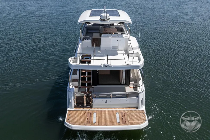 Slide: The Image of 2026 Beneteau Swift Trawler 48, rear view on open water. - 30