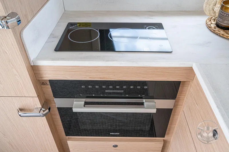 Slide: The Image of Modern kitchen in 2026 Beneteau Swift Trawler 48 with sleek stovetop and oven. - 37