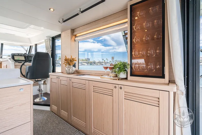 Slide: The Image of Interior of 2026 Beneteau Swift Trawler 48, featuring elegant cabinetry and scenic window view. - 39