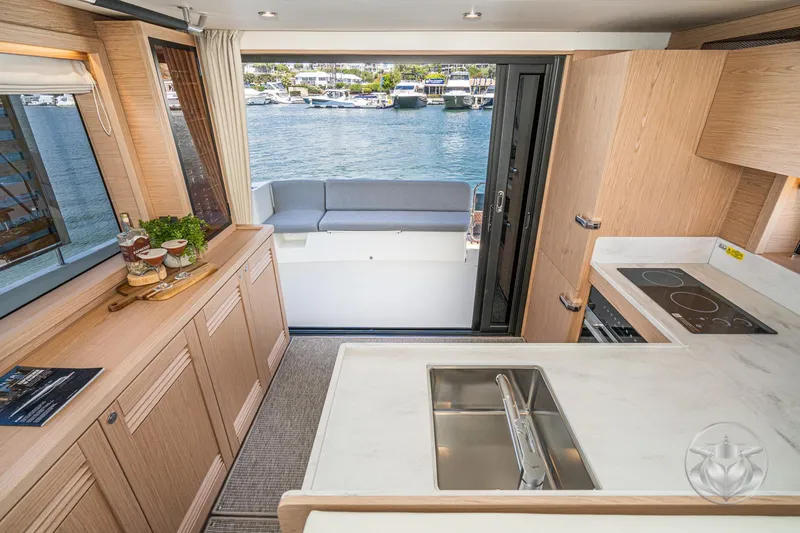Slide: The Image of Interior of 2026 Beneteau Swift Trawler 48, featuring modern kitchen and waterfront view. - 4
