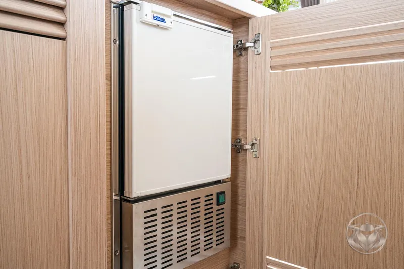 Slide: The Image of Built-in refrigerator in 2026 Beneteau Swift Trawler 48, wooden cabinet detail. - 41