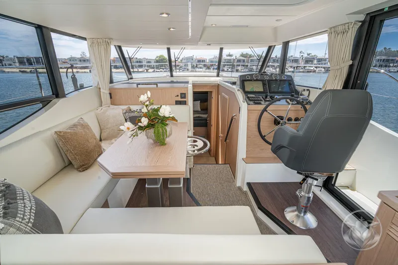 Slide: The Image of Luxurious interior of 2026 Beneteau Swift Trawler 48 with helm, seating, and elegant decor. - 43