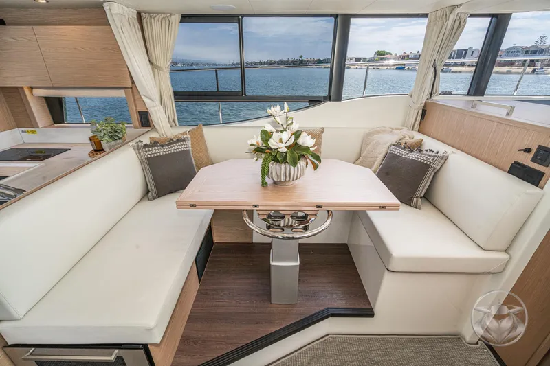 Slide: The Image of Interior of 2026 Beneteau Swift Trawler 48 with elegant dining area and scenic view. - 44