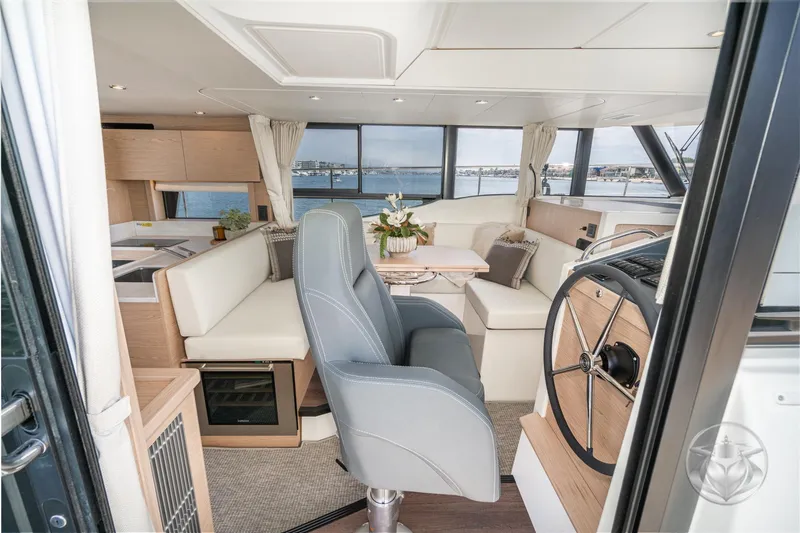 Slide: The Image of Luxurious interior of 2026 Beneteau Swift Trawler 48 with modern helm and seating area. - 46