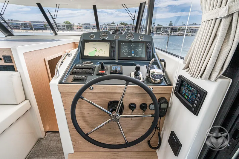 Slide: The Image of 2026 Beneteau Swift Trawler 48 helm with modern navigation and control systems. - 47
