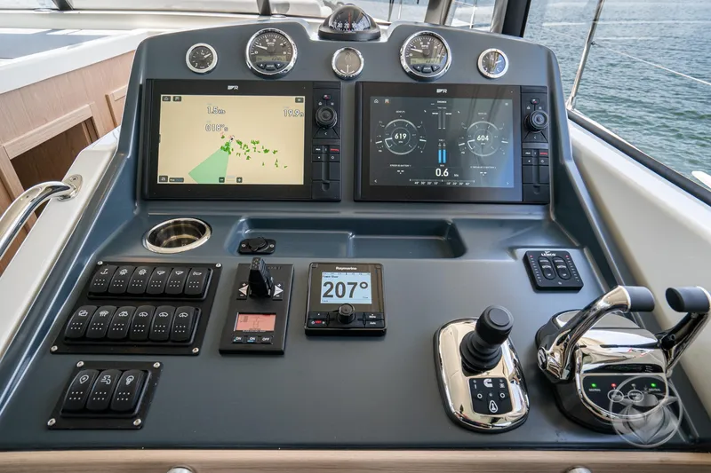 Slide: The Image of 2026 Beneteau Swift Trawler 48 helm with advanced navigation and control systems. - 48