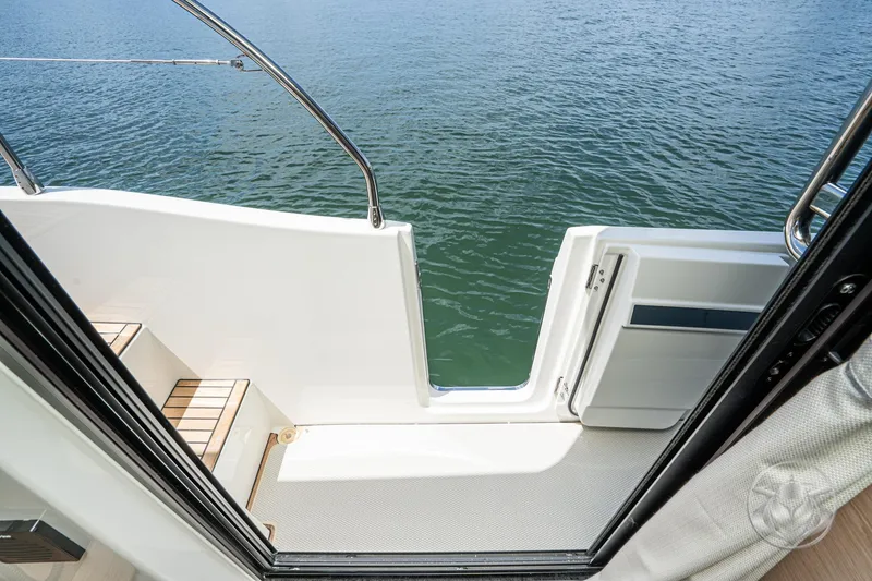 Slide: The Image of Beneteau Swift Trawler 48, 2026 model, open door to water view. - 50