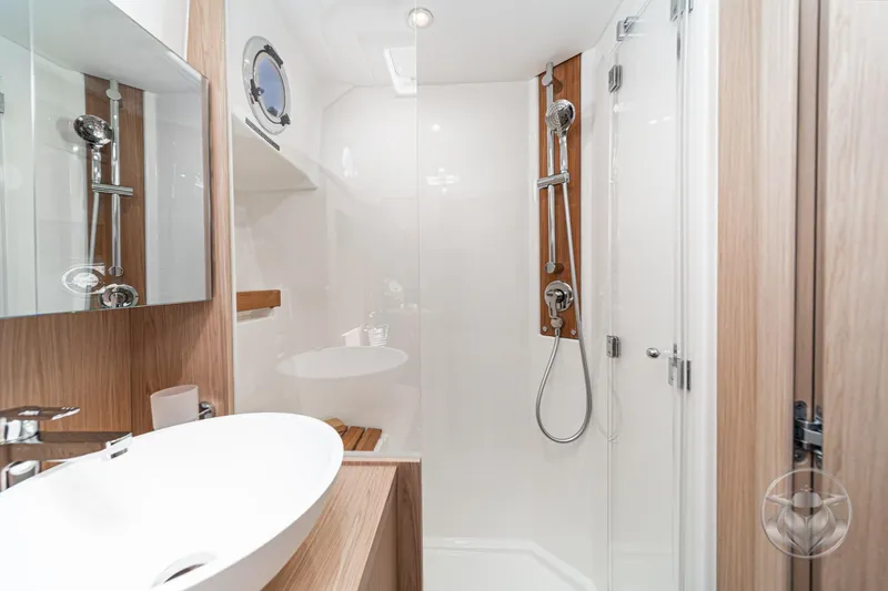 Slide: The Image of Luxurious bathroom in 2026 Beneteau Swift Trawler 48 with modern fixtures and elegant design. - 54