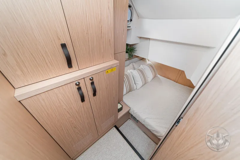 Slide: The Image of Cozy cabin interior of 2026 Beneteau Swift Trawler 48 with wooden cabinetry and bed. - 55