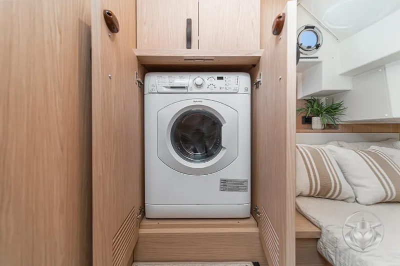 Slide: The Image of Laundry area with washing machine in 2026 Beneteau Swift Trawler 48 interior. - 57