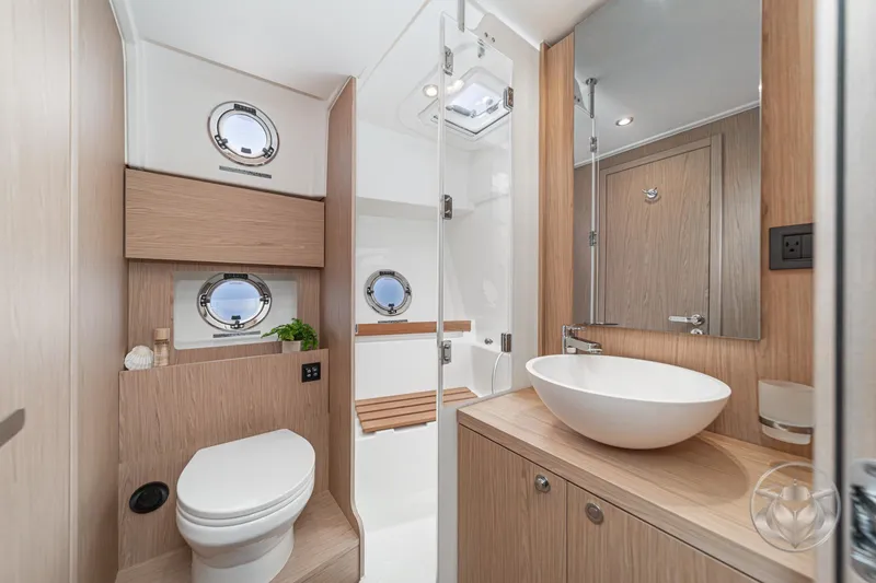 Slide: The Image of Luxurious bathroom in 2026 Beneteau Swift Trawler 48 with modern fixtures and wooden accents. - 59