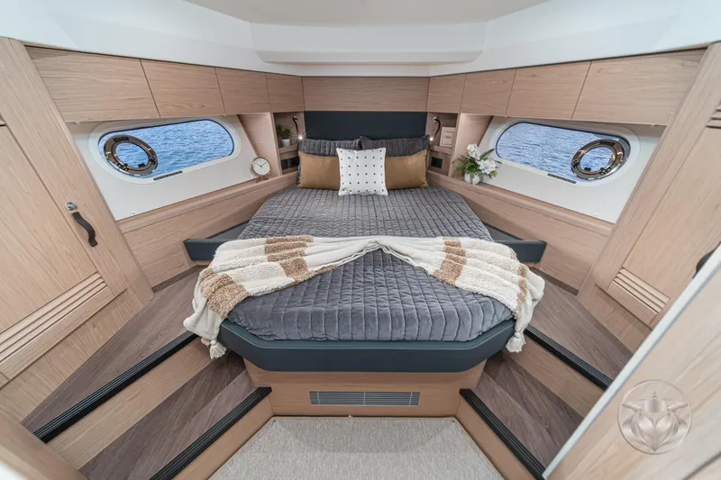 Slide: The Image of Luxurious cabin interior of 2026 Beneteau Swift Trawler 48 with cozy bedding and elegant decor. - 6