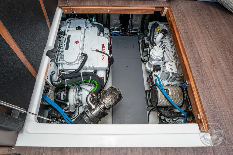 Slide: The Image of Engine room of 2026 Beneteau Swift Trawler 48, showcasing dual engines and mechanical components. - 61