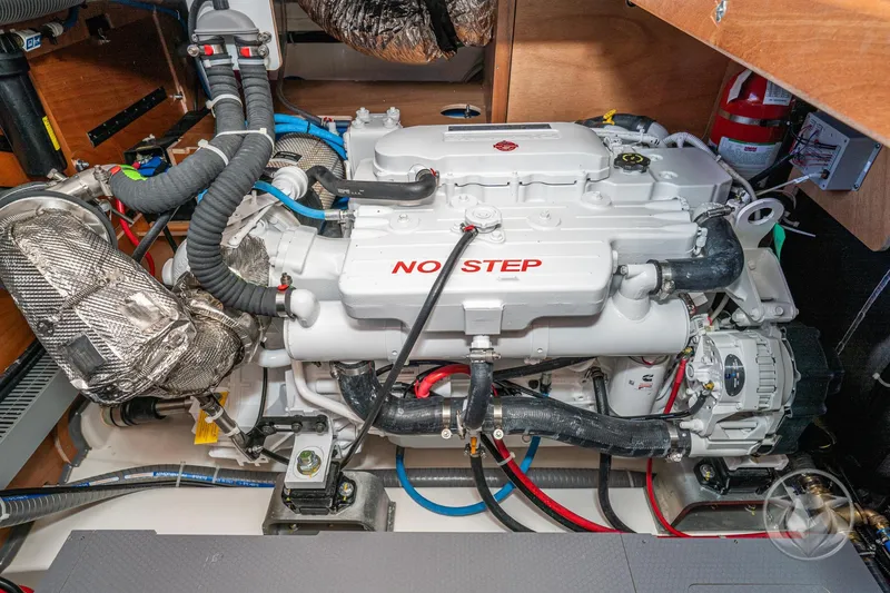 Slide: The Image of Engine room of 2026 Beneteau Swift Trawler 48, featuring a modern marine engine. - 62