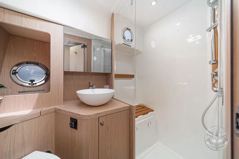 Slide: The Image of Luxurious bathroom in 2026 Beneteau Swift Trawler 48, featuring modern fixtures and elegant wood accents. - 7