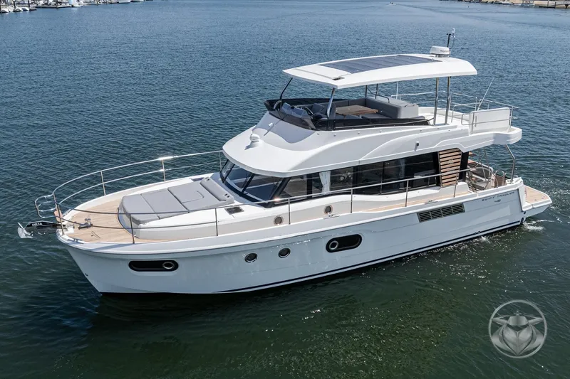 Slide: The Image of 2026 Beneteau Swift Trawler 48 cruising on calm waters, showcasing sleek design and spacious deck. - 8
