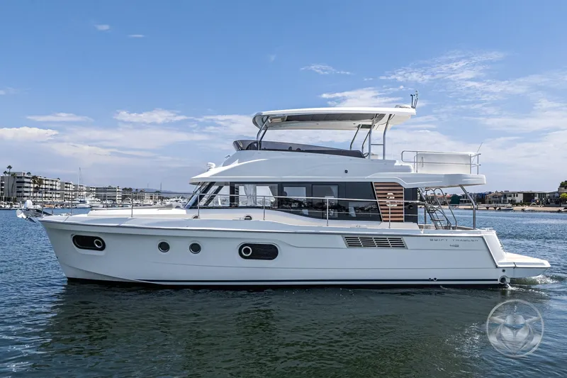 Slide: The Image of 2026 Beneteau Swift Trawler 48 cruising on calm waters under a clear sky. - 9