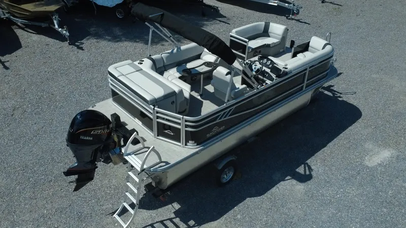 Slide: The Image of 2025 G3 SunCatcher Select 20 Cruise pontoon boat with Yamaha engine, parked on gravel. - 24