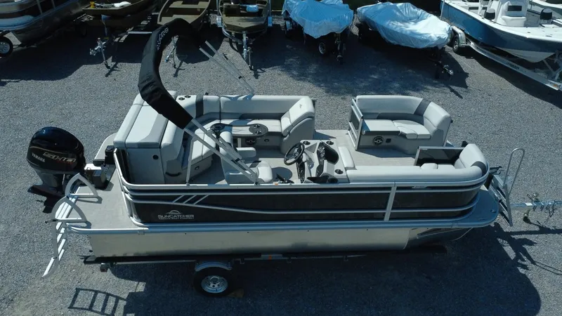 Slide: The Image of 2025 G3 SunCatcher Select 20 Cruise pontoon boat on trailer, parked in a lot. - 25