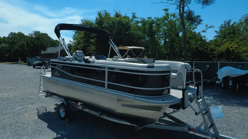 Slide: The Image of 2025 G3 SunCatcher Select 20 Cruise pontoon boat on trailer, parked outdoors. - 30