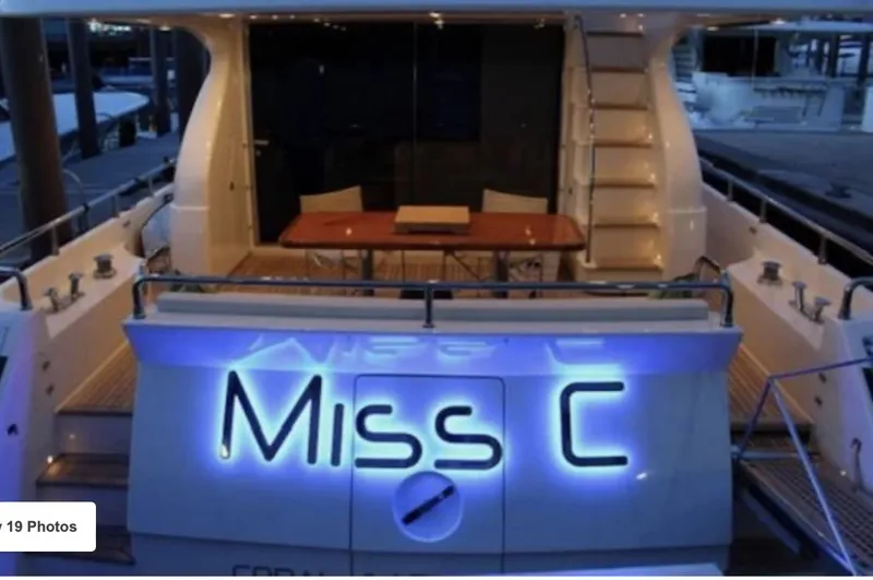 Slide: The Image of Aft view of 2009 Uniesse 65 MY yacht, illuminated with "Miss C" signage. - 2
