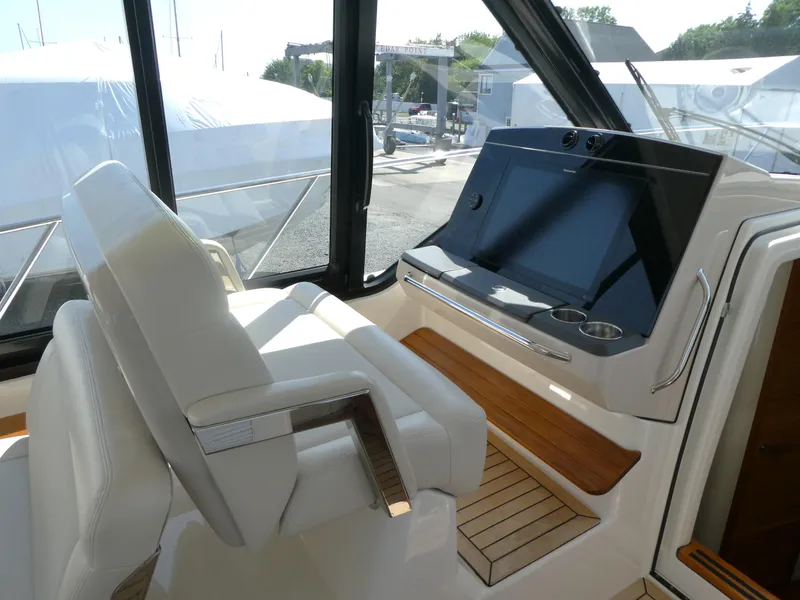 Slide: The Image of 2021 Boston Whaler 405 Conquest helm with modern controls and comfortable seating. - 13