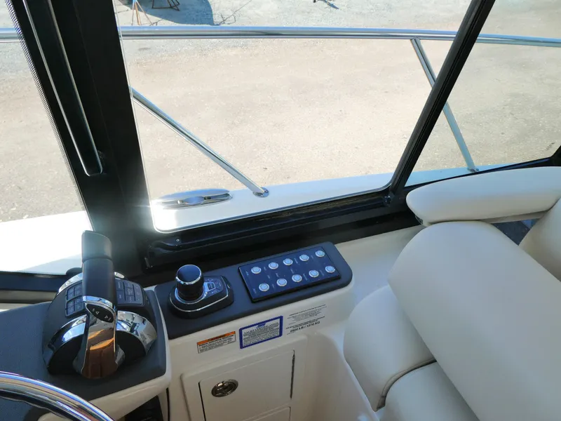 Slide: The Image of Interior view of 2021 Boston Whaler 405 Conquest helm controls and seating. - 14