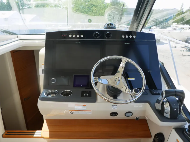 Slide: The Image of Helm of 2021 Boston Whaler 405 Conquest with modern controls and steering wheel. - 15