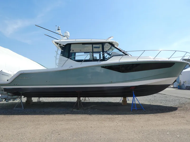 Slide: The Image of 2021 Boston Whaler 405 Conquest boat on stands, side view, outdoors. - 2