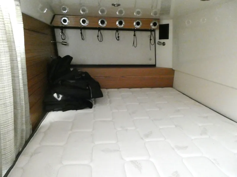 Slide: The Image of Interior cabin of 2021 Boston Whaler 405 Conquest with bed and storage hooks. - 22