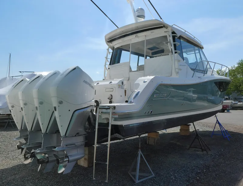 Slide: The Image of 2021 Boston Whaler 405 Conquest boat with multiple outboard engines on display. - 3