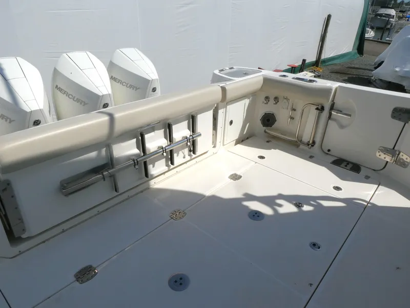 Slide: The Image of Boston Whaler 405 Conquest 2021 boat deck with Mercury engines and fishing rod holders. - 4